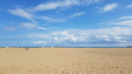 Fototapeta na wymiar Family time leisure travel to sandy beach in Valencia Spain Europe on a bright sunny weekend.