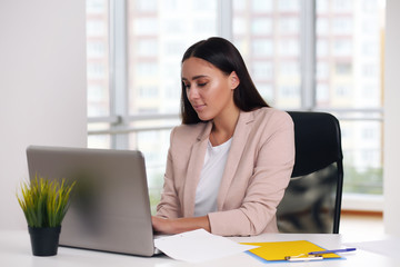 businessman in a pink jacket sitting at a laptop in the office