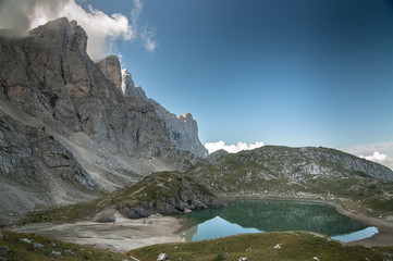 Fototapeta na wymiar Coldai lake as seen from the trail descending from Coldai refuge on Alt Via 1 trek to Vazzoler refuge, Civetta mountain group, Dolomites, Italy.