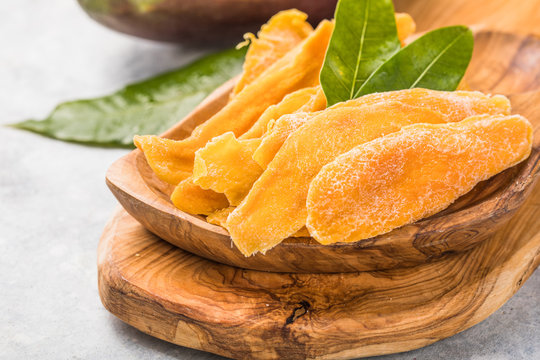 Dried mango background. Candied slices of mango fruit close-up.