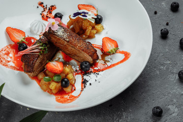 Duck breast with strawberry sauce. bon appetit. Duck breast, strawberry sauce, apple salsa with cinnamon, berries. top food background. copy space