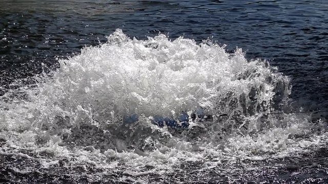 Slow motion picture of an aeration system in a lake, which should increase the oxygen content of the water, close-up