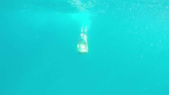 man diving underwater with seabob