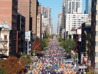 People running the marathon in Manhattan. A street filled with people. Sport event