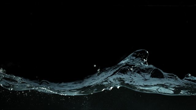 Super slow motion of waving water isolated on black background. Filmed on high speed cinema camera, 1000 fps.