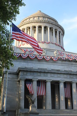 American flag next to the capitol with columns
