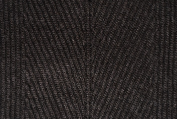 Black textile background. Background from woolen knitted fabric close up.