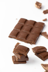 chocolate pieces on white background