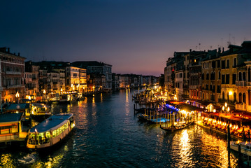 View of the  Canal Grande its palaces, and the water ferry station of Rialto in Venice at sunset from the Rialto Bridge