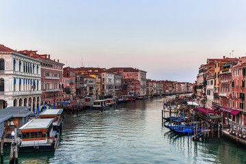 View of the  Canal Grande its palaces, and the water ferry station of Rialto in Venice at sunrise from the Rialto Bridge