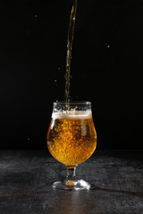 glass of beer on black background