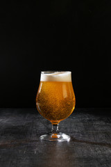 glass of beer on black background