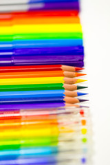 Obraz premium Back to school. School supplies pens, pencils, markers are laid out in the form of a rainbow. Space for text