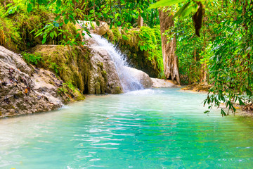 Tropical landscape with beautiful waterfall, wild rainforest with green foliage and flowing water. Erawan National park, Kanchanaburi, Thailand © Pavlo Vakhrushev