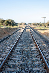 Fototapeta na wymiar Rusty steel and wood train tracks in the Extremadura countryside