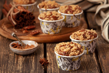  Muffins with apples and cinnamon on wooden background