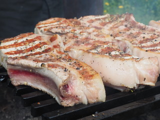 pork steaks on the bone on the grill. delicious pork loin steaks on the bone.