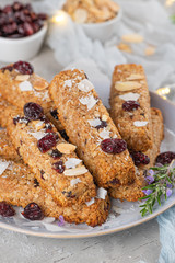 Granola bar. Healthy snack. Cereal granola bar with nuts, fruit, coconut and cranberries on a christmas table