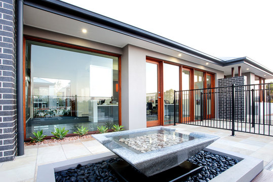 Backyard of luxury house with big glass door and windows