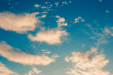Dramatic blue sky with yellow clouds, vintage abstract background