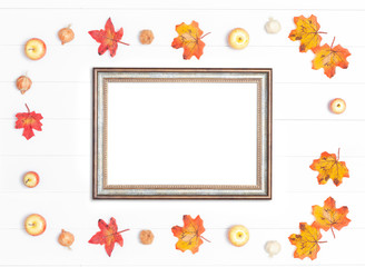 Fototapeta na wymiar Vintage frame and bright autumn leaves on a white wooden background