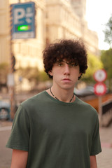 Fototapeta premium caucasian boy with afro looking at the camera outdoors