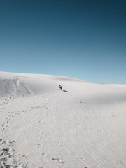 Child climbing up the sand dune