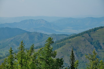 Russia. mountain Altai. Due to forest fires in the Krasnoyarsk territory, the mountains are shrouded in smoke for many kilometers, which makes their contours very expressive.