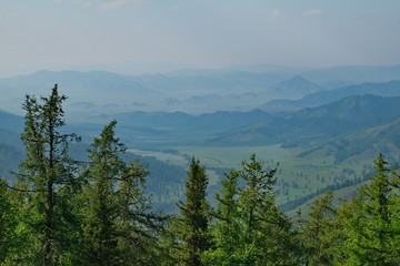 Russia. mountain Altai. Due to forest fires in the Krasnoyarsk territory, the mountains are shrouded in smoke for many kilometers, which makes their contours very expressive.