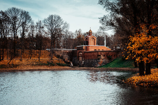 Autumn Park with a pond and a Christian church