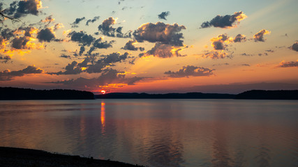 Fototapeta na wymiar sunrise with clouds over the lake