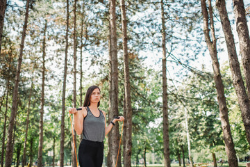 Young woman exercising with jumping rope at public park