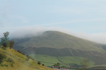 Mist on hill tops with bright blue sky