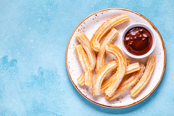 churros with powdered sugar and chocolate sauce