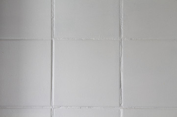 Old square white tiles. Background