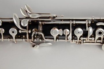 Old oboe on a gray background. Musical instrument