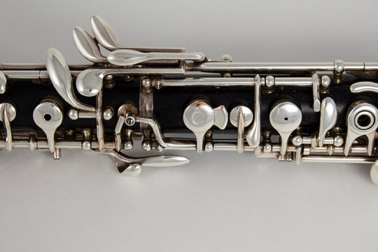 Old oboe on a gray background. Musical instrument