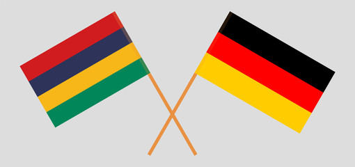 Crossed and waving flags of Mauritius and Germany