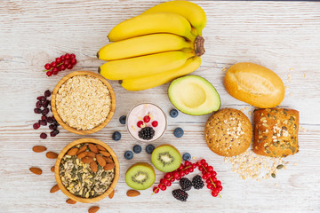 Fruit and Bread Whole grains and nuts, yogurt mix with Cherry , banana, avocado in the wooden table. Breakfast for Health and Diet concept