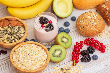 Fruit and Bread Whole grains and nuts, yogurt mix with Cherry , banana, avocado in the wooden table. Breakfast for Health and Diet concept