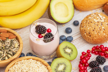 Naklejka na ściany i meble Fruit and Bread Whole grains and nuts, yogurt mix with Cherry , banana, avocado in the wooden table. Breakfast for Health and Diet concept