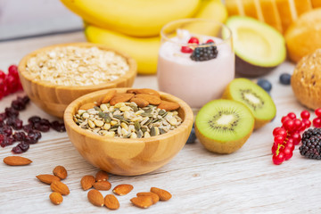 Fruit and Bread Whole grains and nuts, yogurt mix with Cherry , banana, avocado in the wooden table. Breakfast for Health and Diet concept