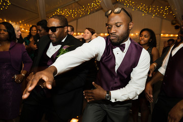 Groom and groomsman dancing at reception