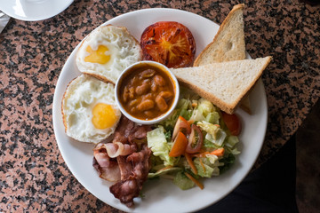 Plate of beans, egg, toast and salad