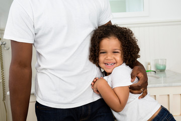 Father and son hugging in bathroom