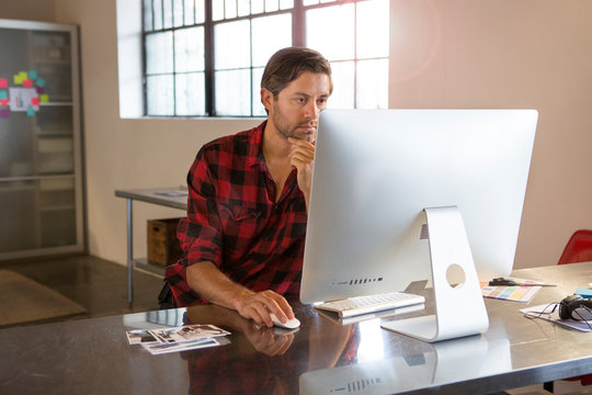 Caucasian businessman using computer in office