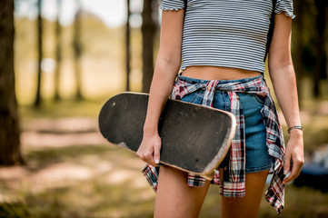 Skater girl holding her skateboard