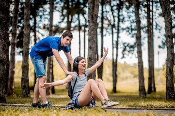 Teenagers with skateboard playing outdoors