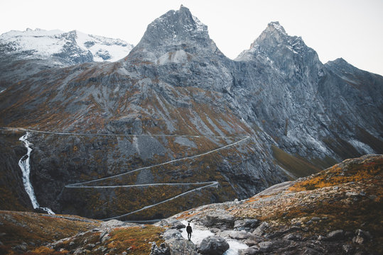 Rear view of man looking at view of Trollstigen road