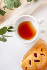 puff buns with raspberries on a vintage plate on a white background close-up. Breakfast with tea. Top view